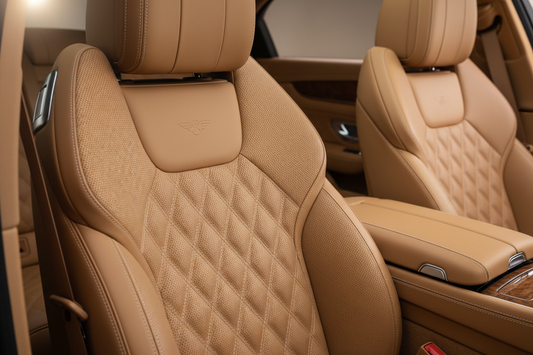 Luxurious tan leather car seat interior — rich texture and stitching detail