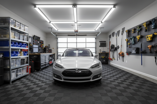 Clean organized garage with interlocking rubber floor tiles and car parked on top