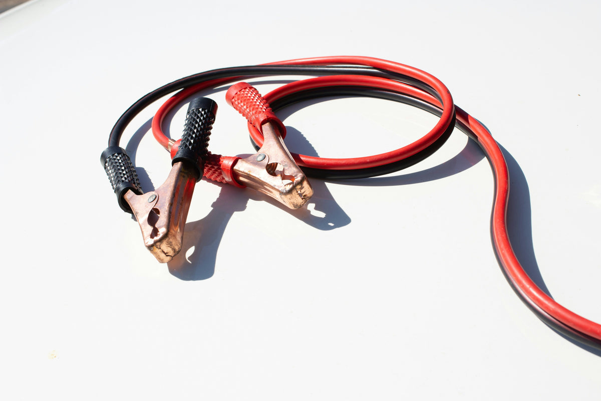 Jump starter connected to a car battery to start vehicle