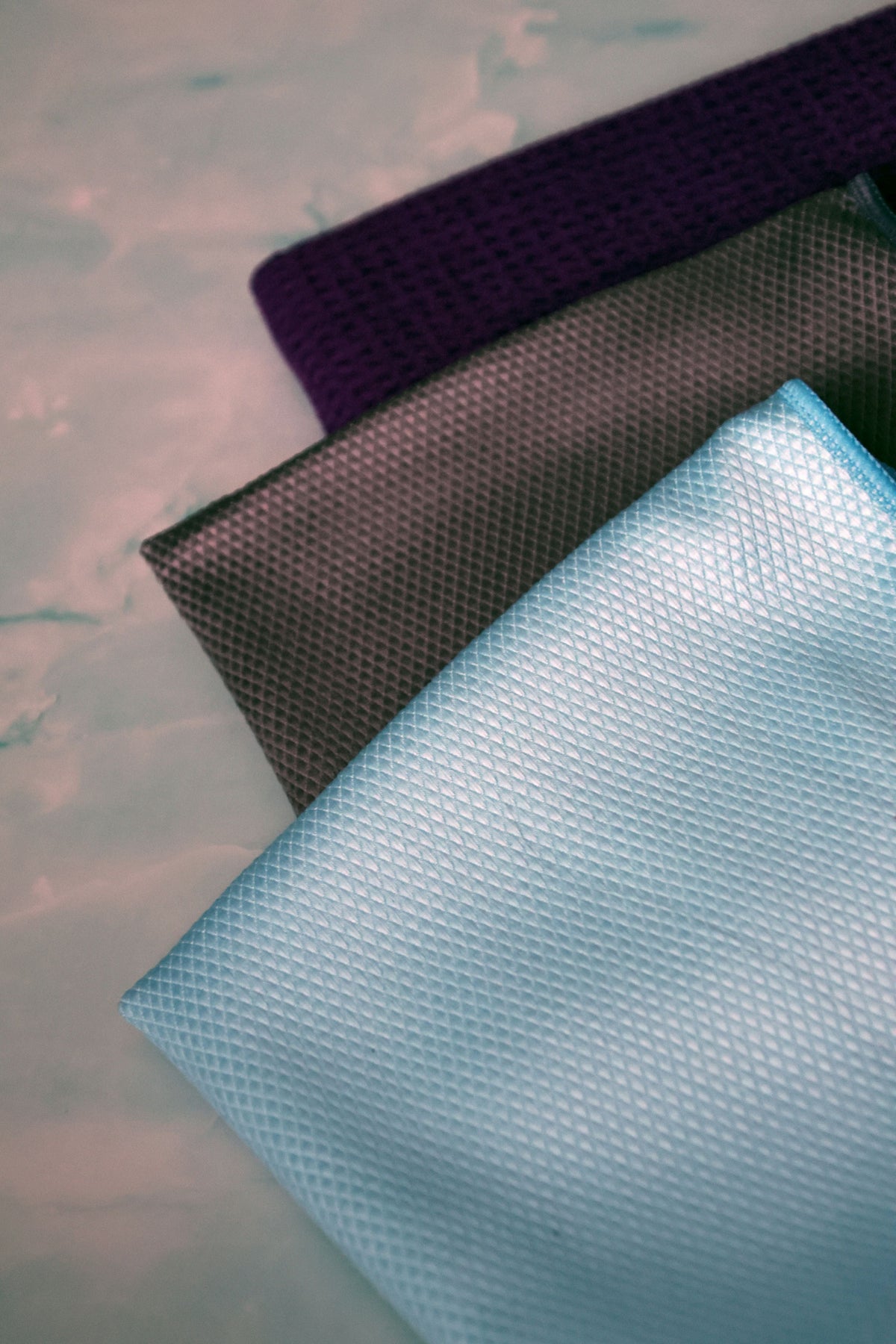 Microfiber towels used for drying and detailing a car surface