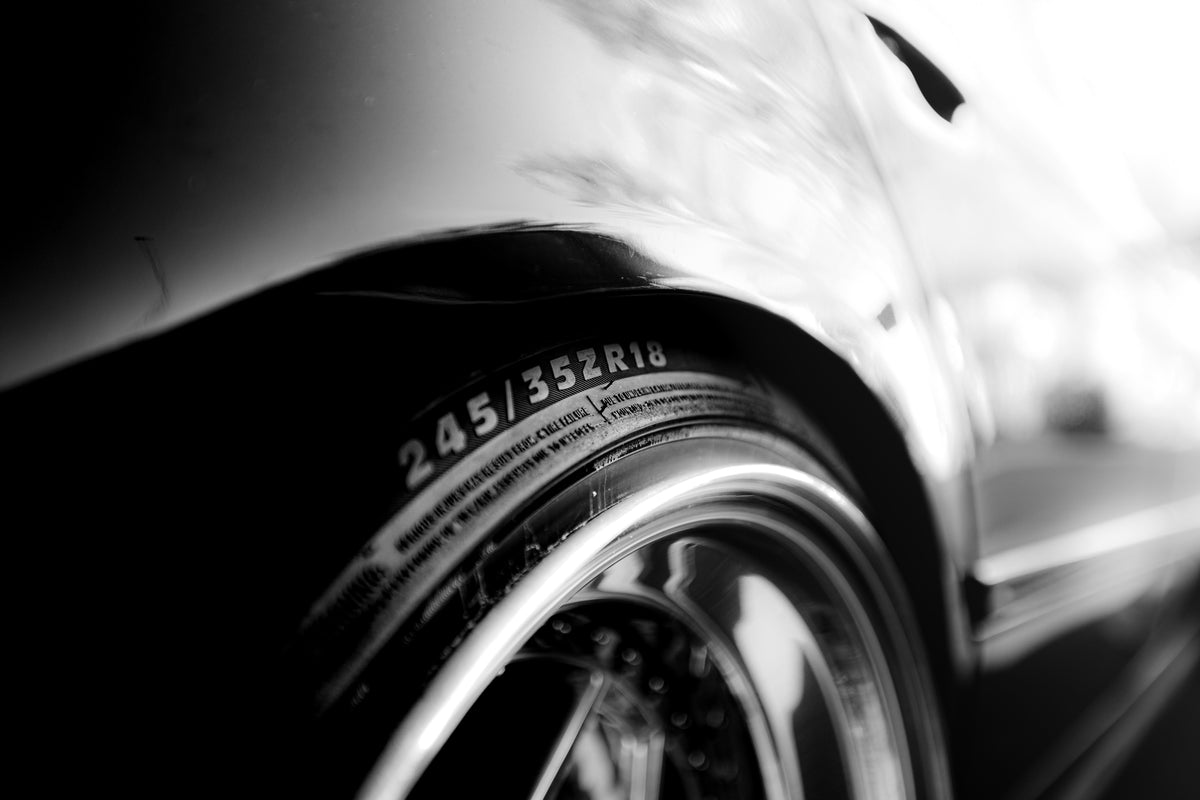 Applying tire shine to enhance gloss and restore tire appearance
