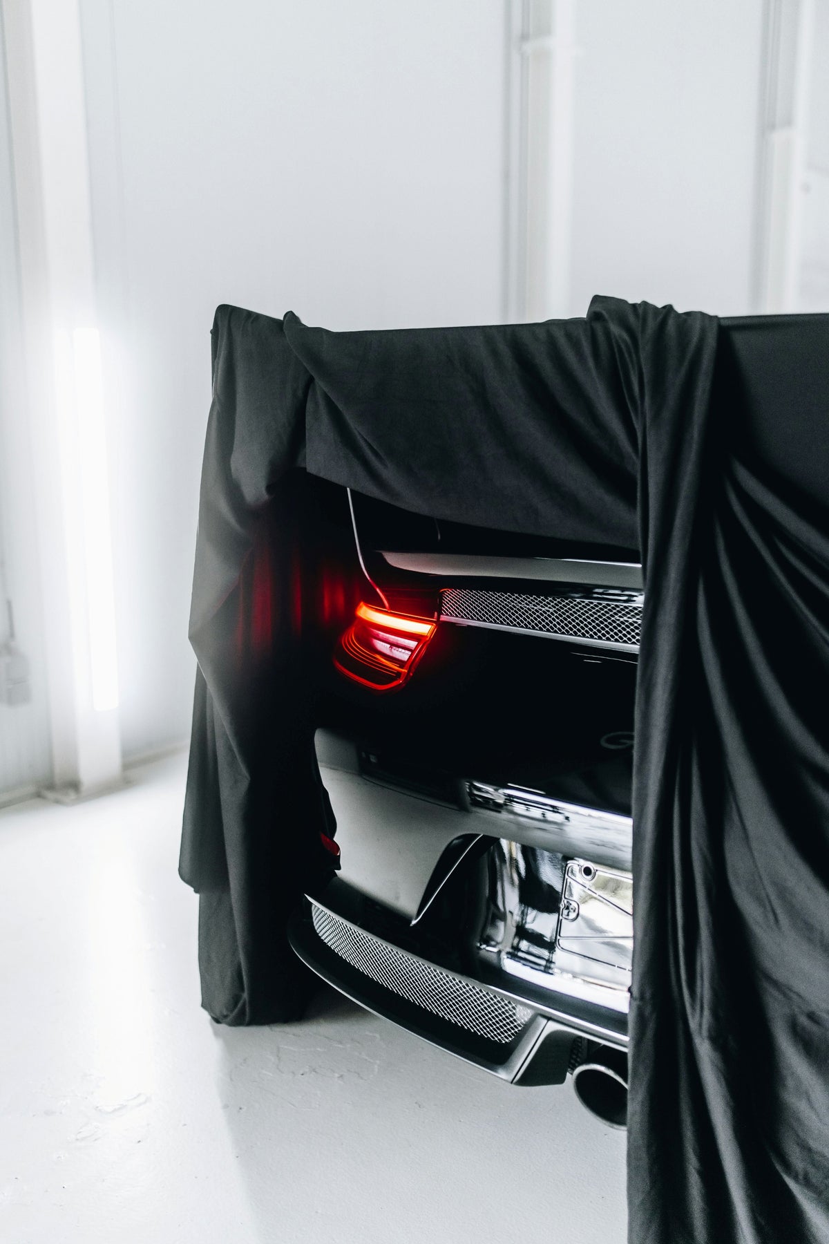 Car covered with protective cover parked outdoors