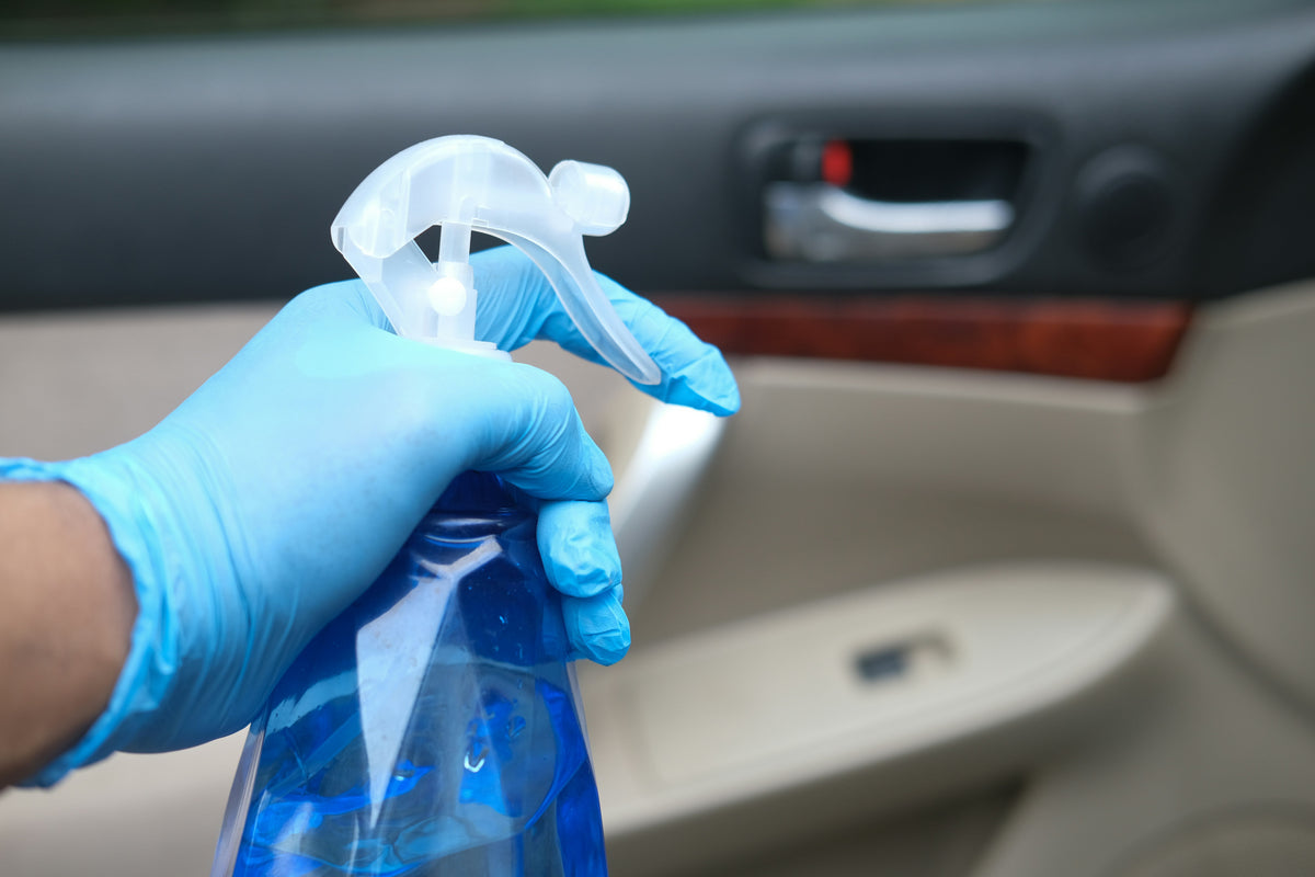 Cleaning car interior dashboard and seats with interior cleaner