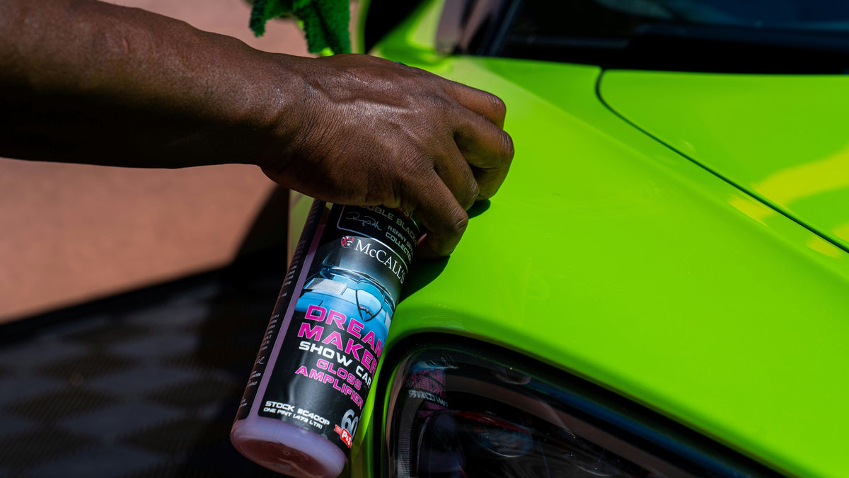 Applying car wax to enhance shine and protect paint surface