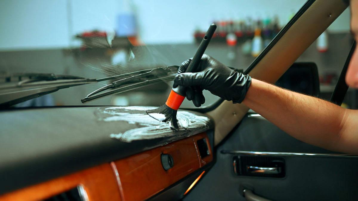Detailing brush cleaning car air vents and interior surfaces